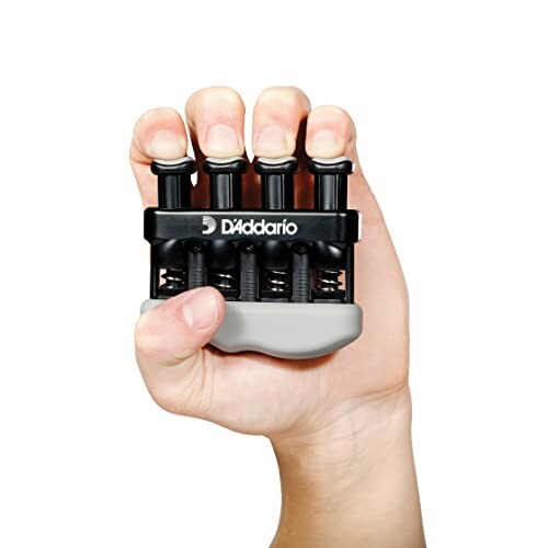 Hand holding a D'Addario grip strength exerciser.