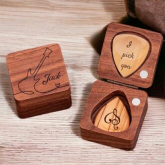 Wooden guitar pick box with personalized engraving.